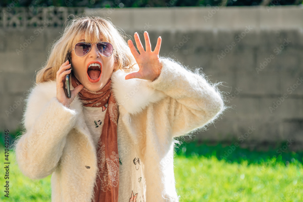woman using mobile phone outdoors with excited expression of excitement and surprise woman using mobile phone outdoors with excited expression of excitement and surprise