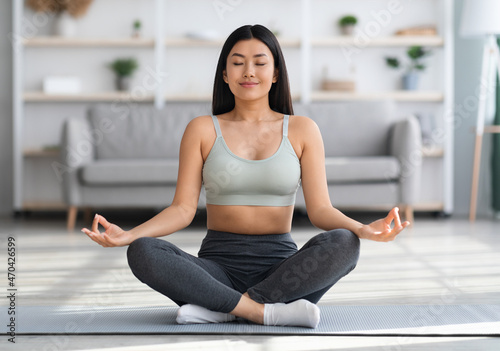 Morning Meditation. Young Beautiful Asian Lady Practicing Yoga At Home
