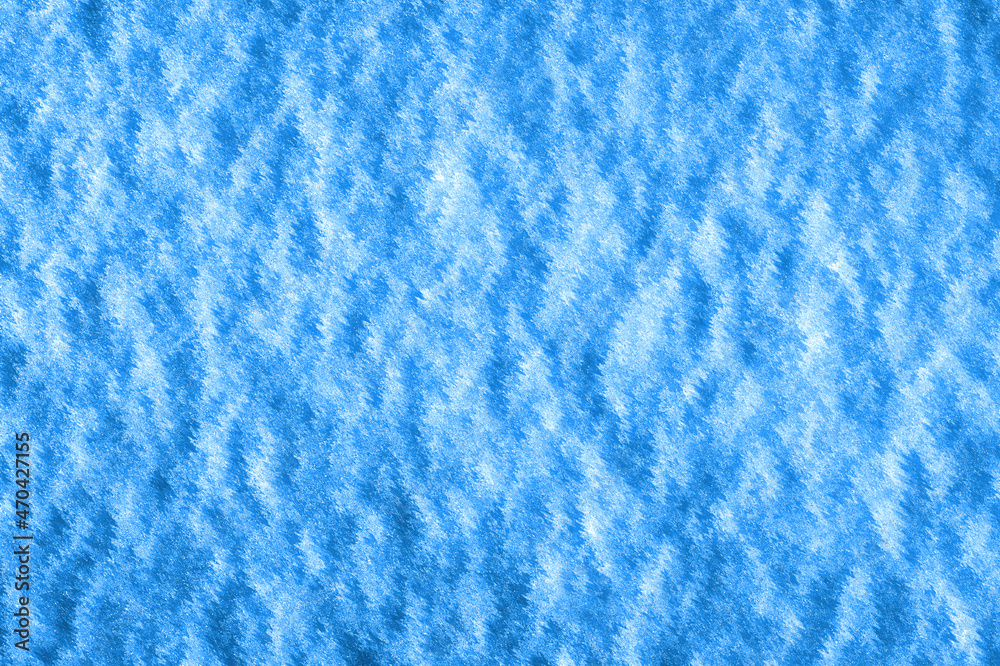 Ice crust on the surface of the snow cover. Dark blue background and snow texture. Ice crust on the surface of the snow cover. Dark blue background and snow texture.