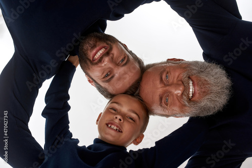 Portrait of three generations of men hug show support