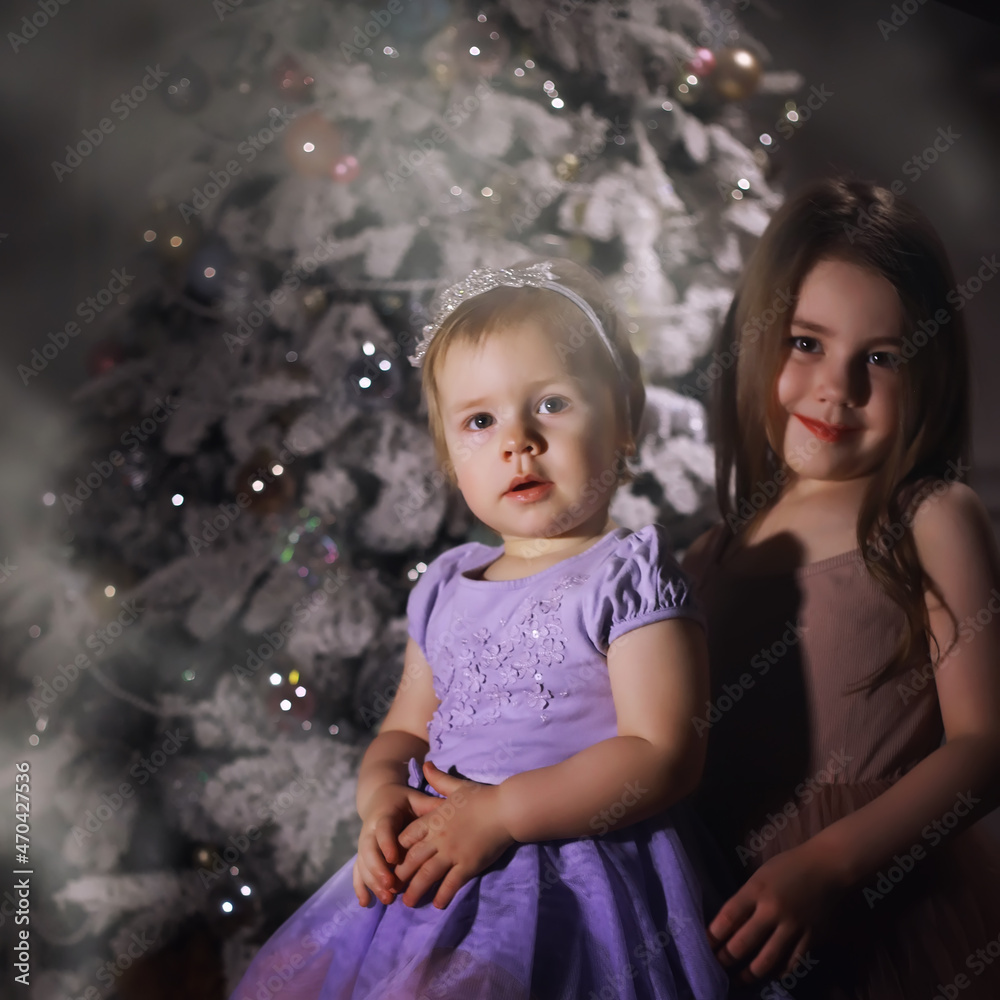 Fototapeta premium Child in smart clothes in front of the Christmas tree. New Years Eve. Waiting for the new year.