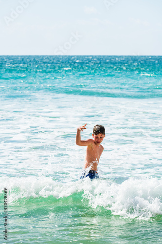 Boy playing in sea, Alvor, Algarve, Portugal, Europe