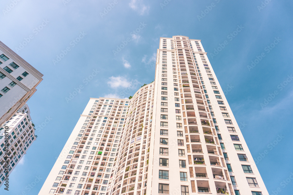 High-rise apartment buildings in the city center. Low angle shot of modern architecture in blue sky. Futuristic cityscape view High-rise apartment buildings in the city center. Low angle shot of modern architecture in blue sky. Futuristic cityscape view