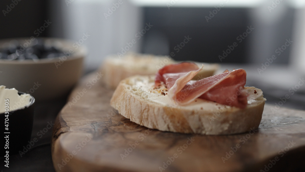 prosciutto over cream cheese on slice of ciabatta