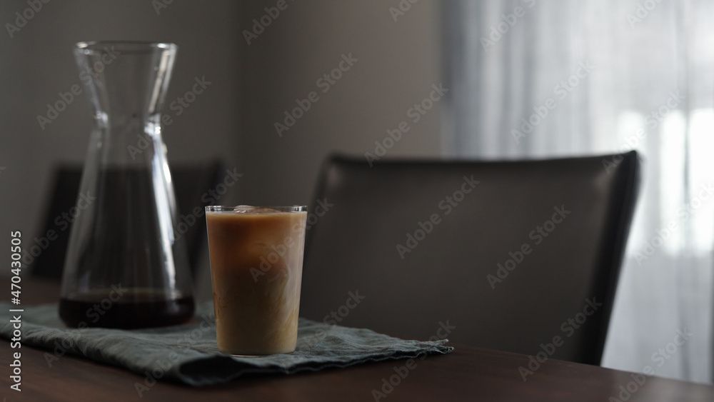 fresh coffee with milk in glass on wood table