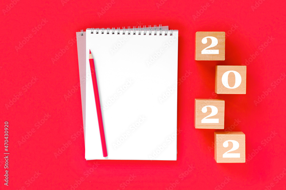 2022 arrange on red background. Notebook with white page for your write. Golden Numbers 2022. Balls, Fir, Pine, goal, New Year, New You and happy holiday concept. Christmas Celebration mock up 2022 arrange on red background. Notebook with white page for your write. Golden Numbers 2022. Balls, Fir, Pine, goal, New Year, New You and happy holiday concept. Christmas Celebration mock up