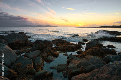 Beautiful nature sunset scenery, rocky coast of Wild atlantic way with beautiful orange skies at county Galway in Ireland 