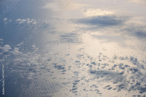 Aerial evening sky and clouds view above ocean from airplane porthole. Sky cloudscape background. Flight to Iceland over the North Atlantic. photo