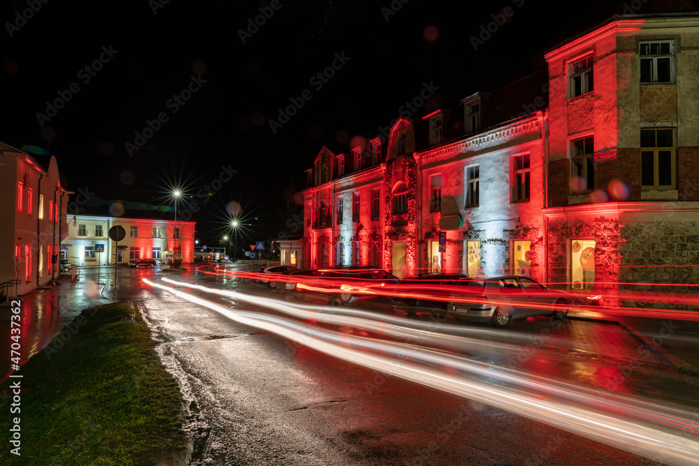 Illuminated buildings at night in Rauna, Latvian national holidays.