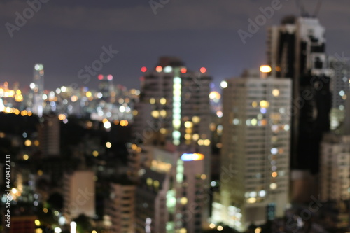 Abstract blurred lights city office building downtown background, beautiful cityscape view in night time.