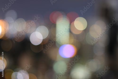 Abstract blurred lights city office building downtown background, beautiful cityscape view in night time. © narin_nonthamand