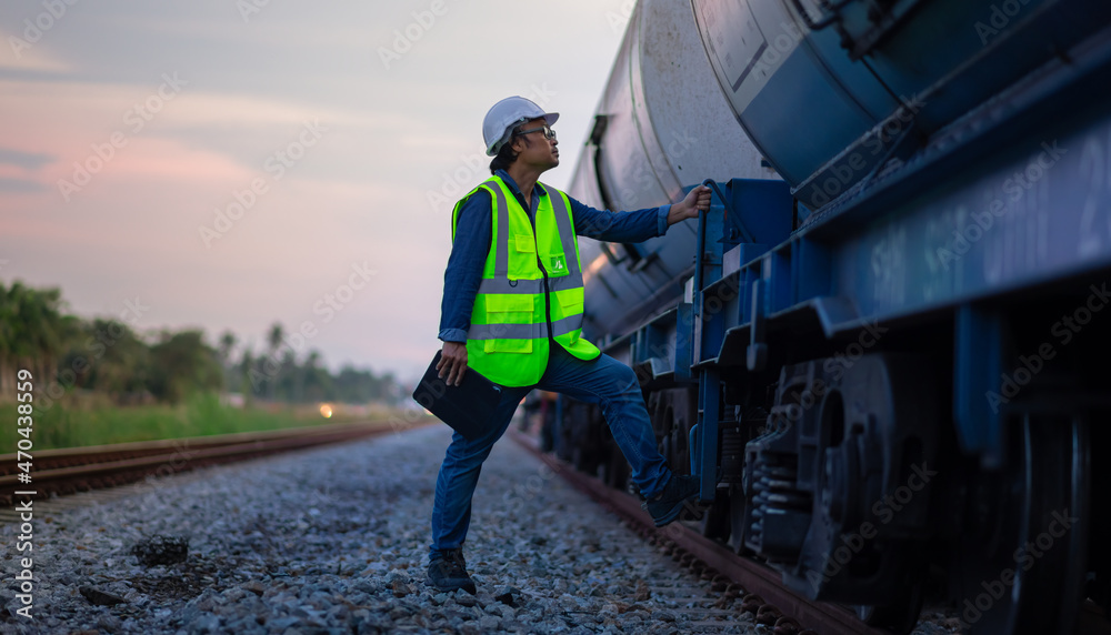 Engineer under inspection and checking construction process railway switch and checking work on railroad station .Engineer wearing safety uniform and safety helmet in work. Engineer under inspection and checking construction process railway switch and checking work on railroad station .Engineer wearing safety uniform and safety helmet in work.