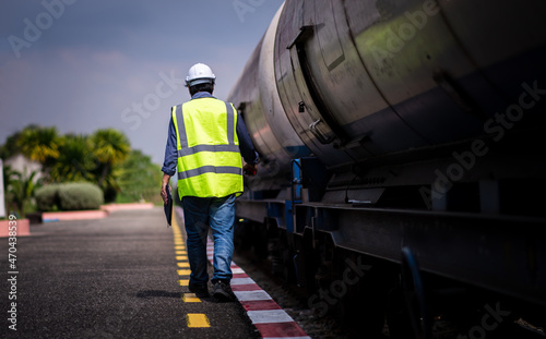 Engineer under inspection and checking construction process railway switch and checking work on railroad station .Engineer wearing safety uniform and safety helmet in work.