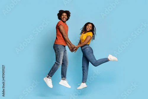 Romantic black loving couple posing over blue