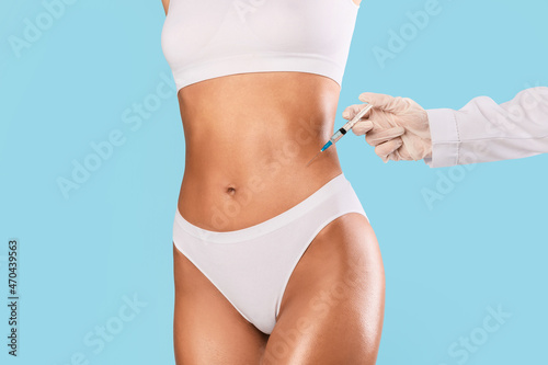 Woman having lipolysis injection treatment at beauty salon © Prostock-studio