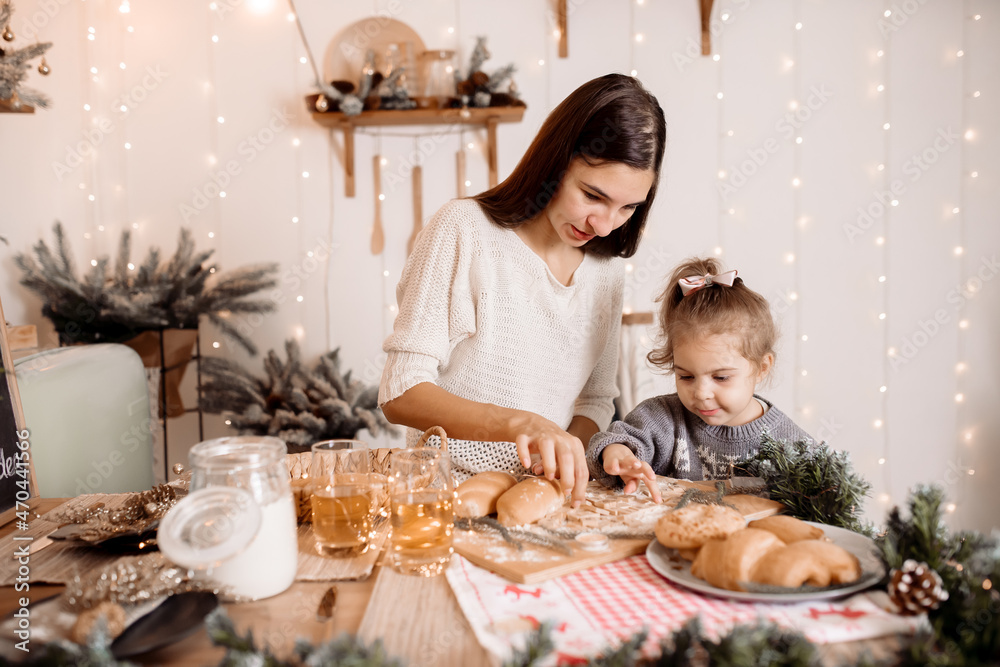 Young parents preparing breakfast with children for christmas