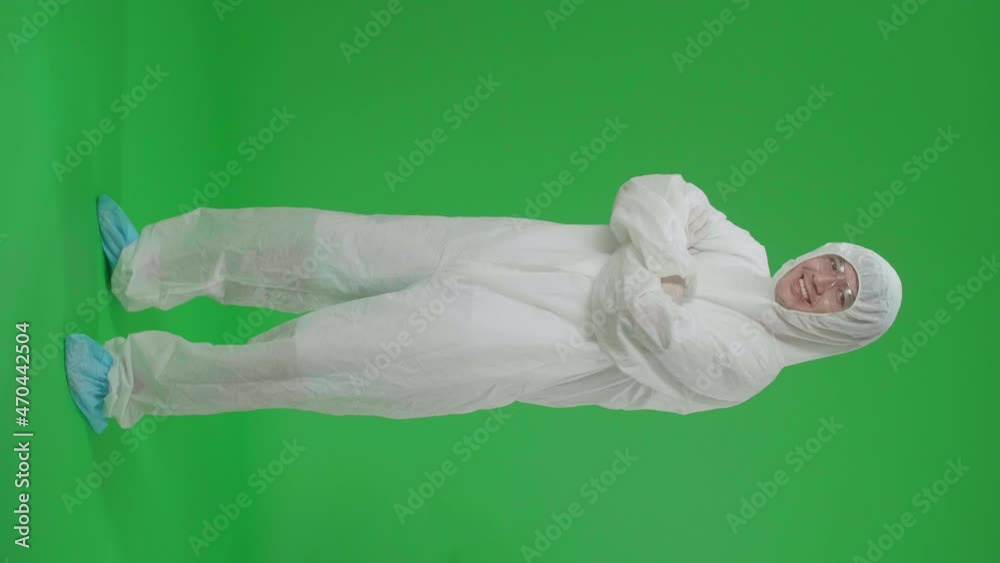 Full Body Of Asian Male Wearing Personal Protective Equipment Uniform Ppe Pose With Arms Crossed In Green Screen Studio
