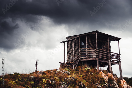 A hunting lodge on the hill in a cloudy moment