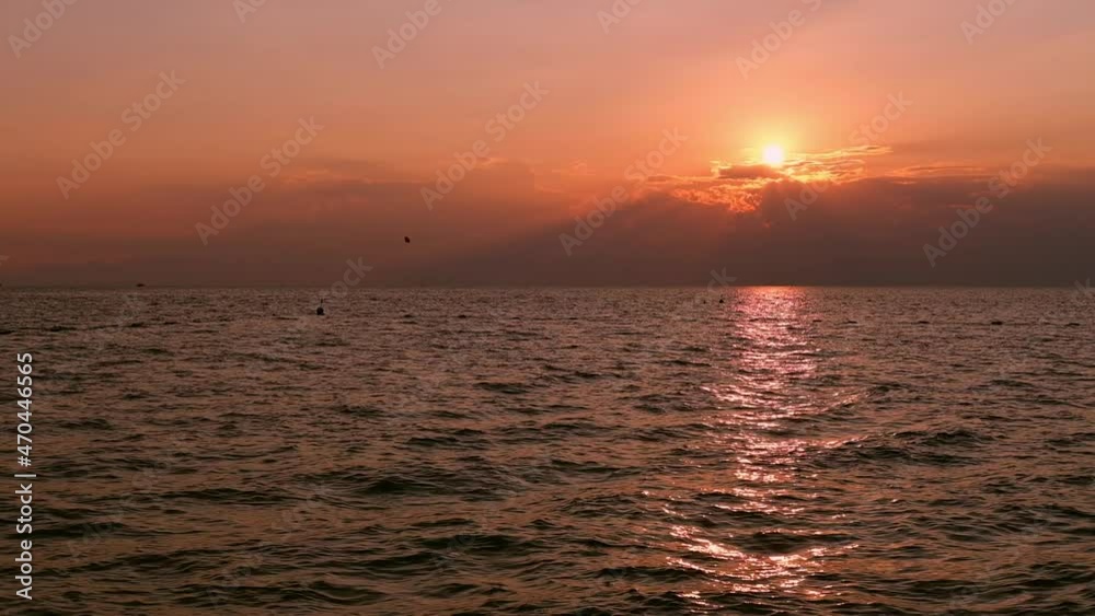 Sea with light waves at sunset. The setting sun is reflected in the water. Sea with light waves at sunset. The setting sun is reflected in the water.