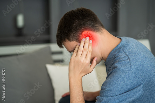Fotografie Man with earache, ear pain at home
