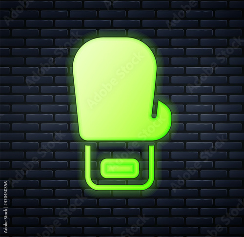 Glowing neon Boxing glove icon isolated on brick wall background. Vector