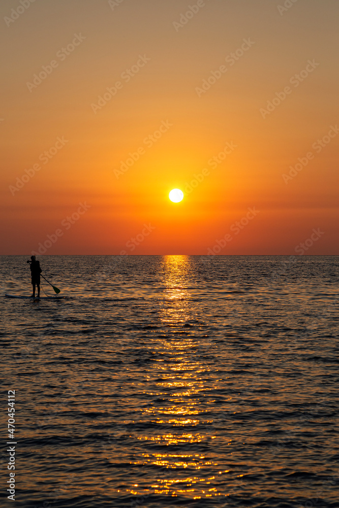 Sunrise on the sea island with servers on the sup.