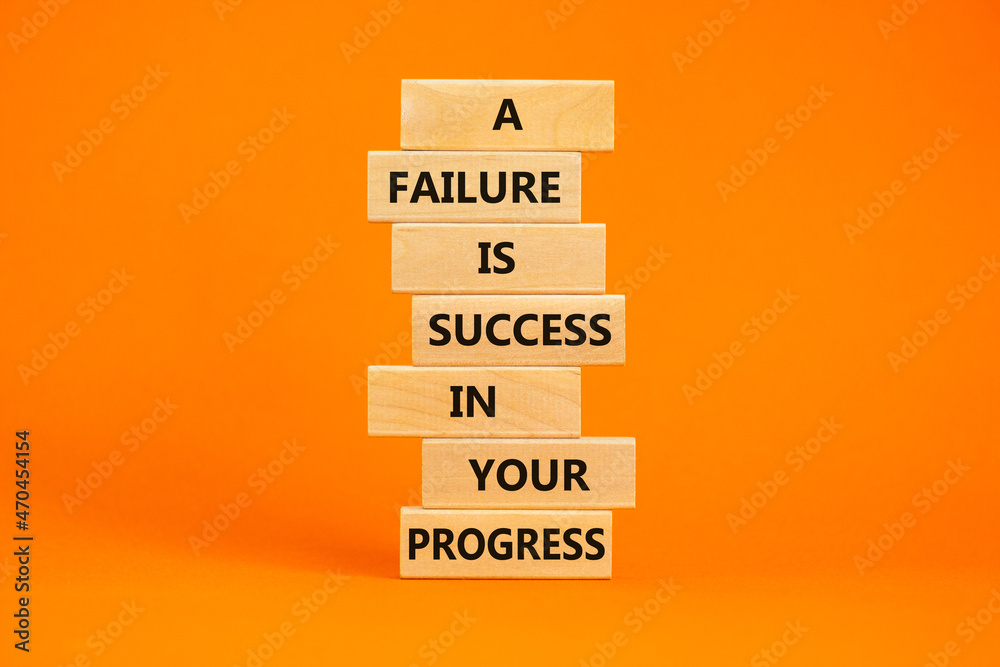Naklejka premium Failure or success symbol. Wooden blocks with words A failure is success in your progress. Beautiful orange background, copy space. Business, failure or success concept.