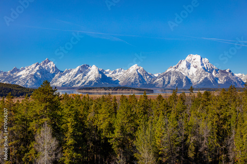 Beautiful snow-capped mountains. Golden autumn forest. Grand Teton National Park, Wyoming, USA