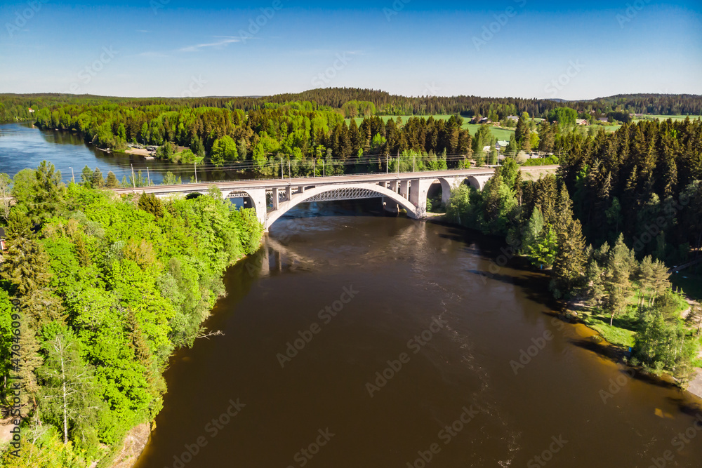 Summer aerial view of bridge and Kymijoki river waters in Finland, Kymenlaakso, Kouvola, Koria Summer aerial view of bridge and Kymijoki river waters in Finland, Kymenlaakso, Kouvola, Koria