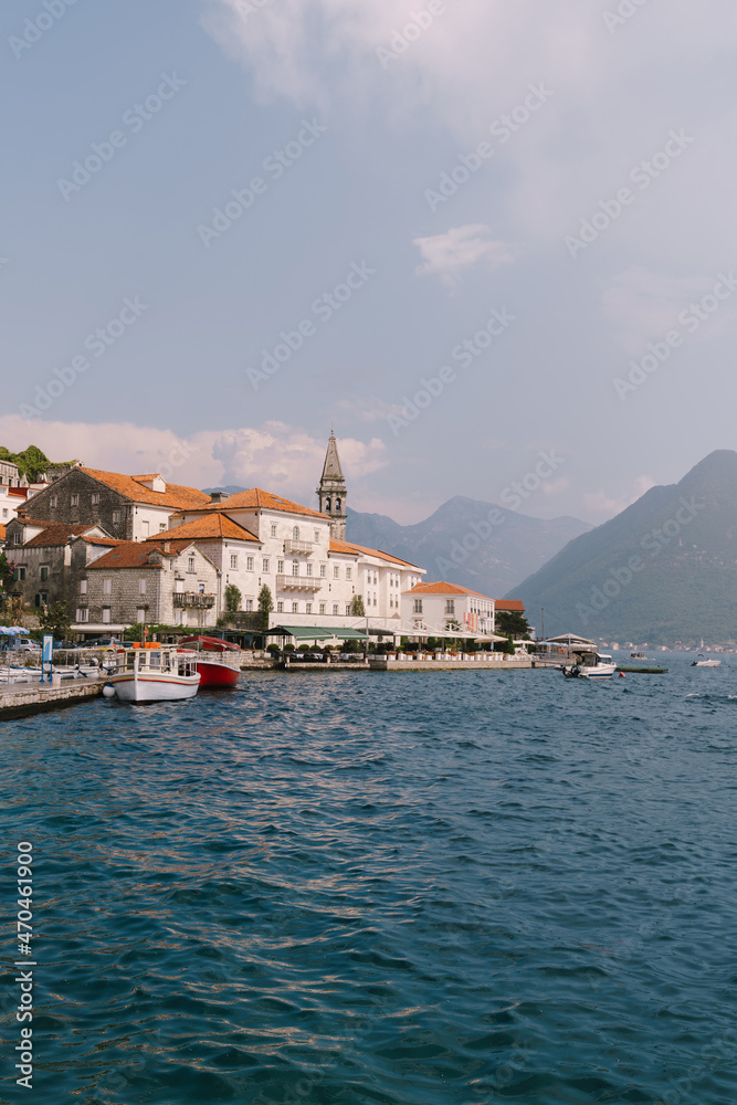 Perast buildings against the background of mountains in the haze. Montenegro