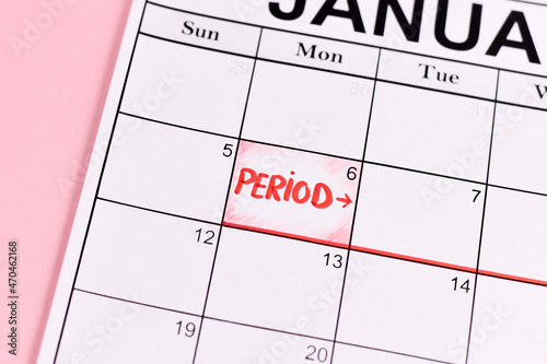 Female period concept with calendar date with period start marked with red word