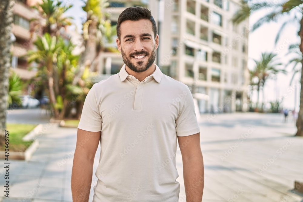 Fototapeta premium Young hispanic man smiling confident walking at street