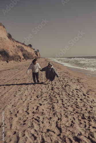 Man and woman enjoy each other, run along the seashore