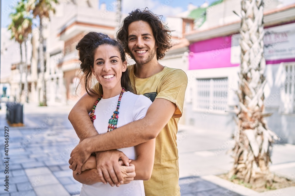 Man and woman couple smiling confident hugging each other at street Man and woman couple smiling confident hugging each other at street