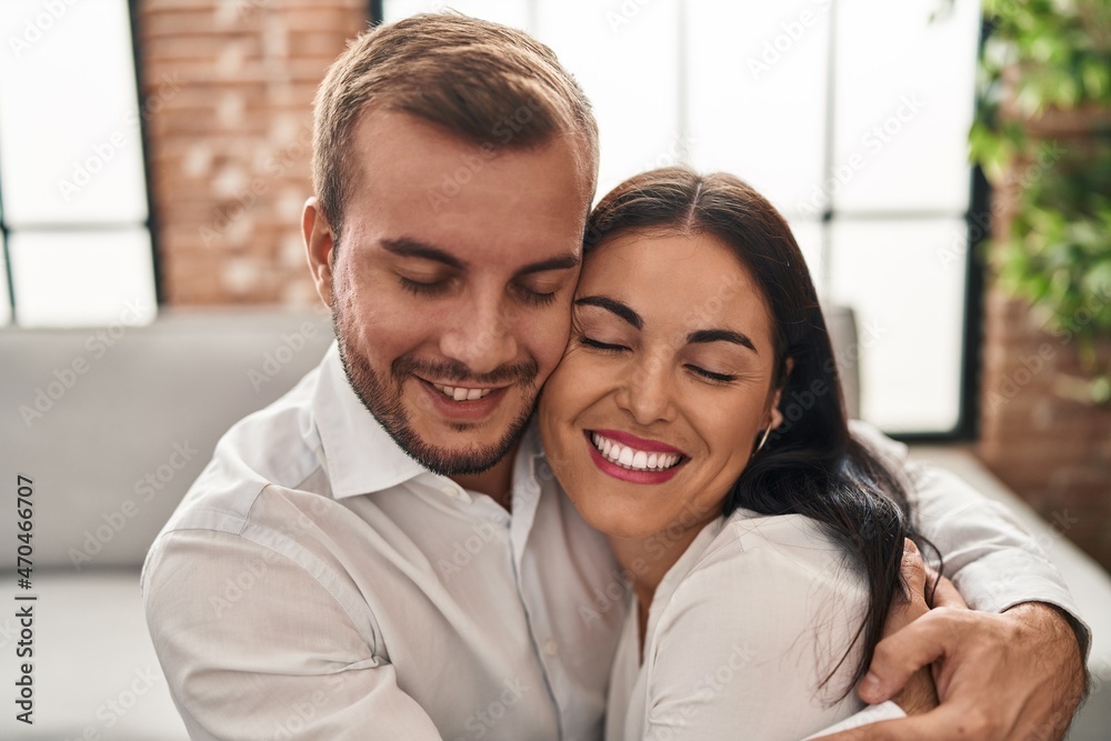 Man and woman couple smiling happy hugging each other at home Man and woman couple smiling happy hugging each other at home