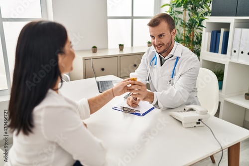Man and woman doctor and patient having medical consultation prescribe pills at clinic