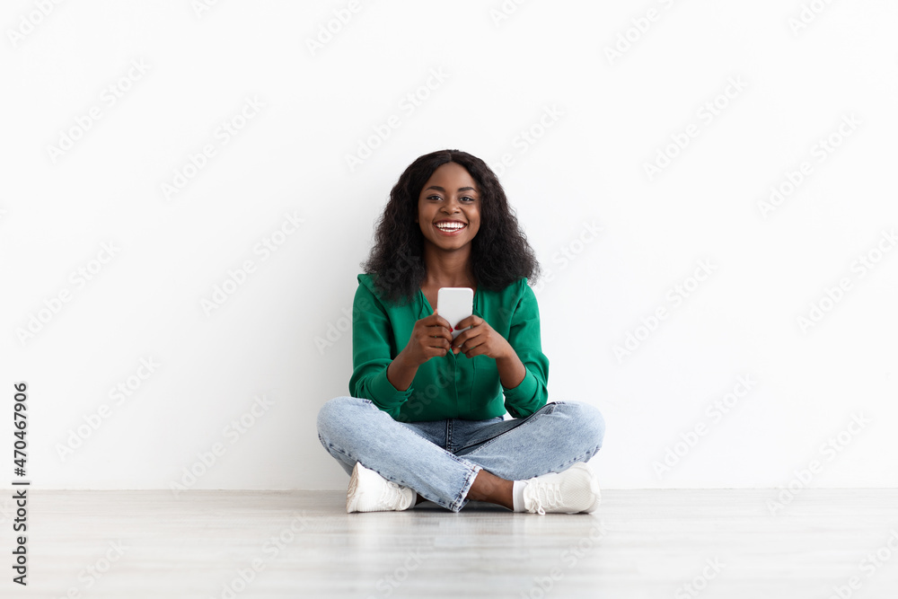 Cheerful african american lady using dating mobile app on cellphone Cheerful african american lady using dating mobile app on cellphone