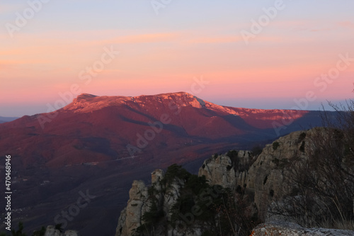 Landscape of the sun rising in the mountains. Red reflexes from the sun on the mountainsides. Areal view