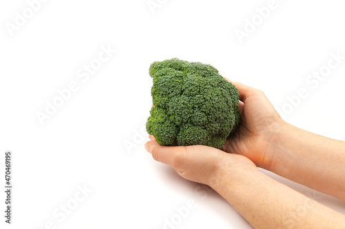 Woman's hand holding brocoli on white background