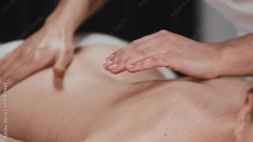 Massage session - masseuse prepares the skin for the massage with soft movements Massage session - masseuse prepares the skin for the massage with soft movements