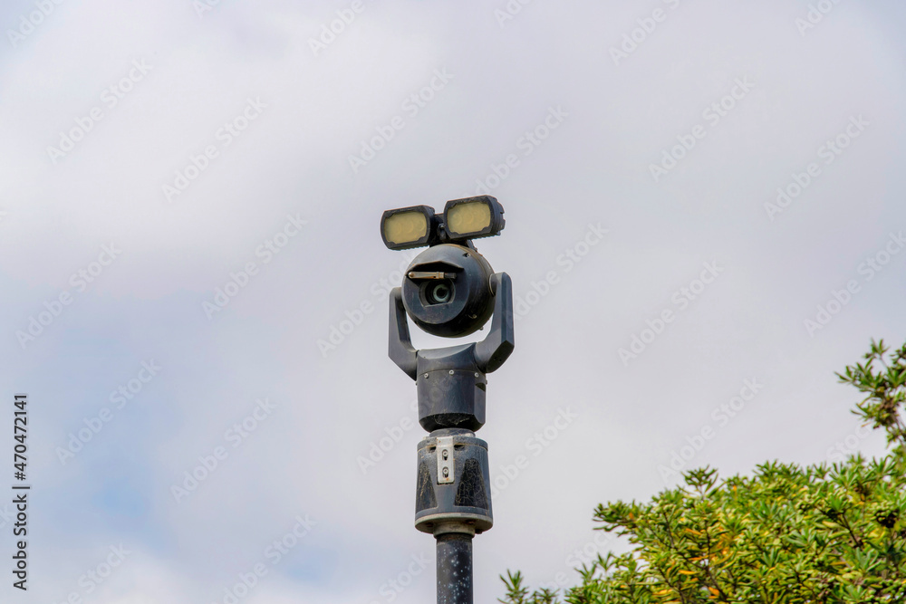 Moving security camera on a post with lights on top Moving security camera on a post with lights on top