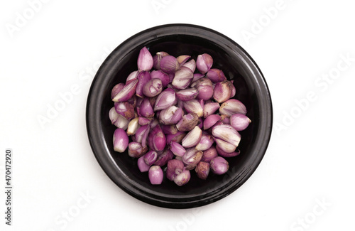 Onions on a black plate on a white background