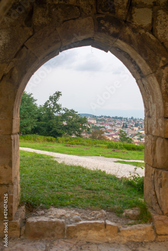 view of old kutaisi through the bell tower arch