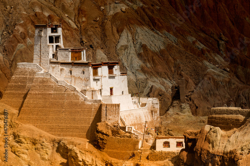 Ruins and Basgo Monastery surrounded with stones and rocks of Himalayan mountains , Leh, Ladakh, union territory, India. Play of light and shadow on backgound mountains. photo