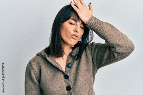 Young hispanic woman wearing casual clothes surprised with hand on head for mistake, remember error. forgot, bad memory concept.