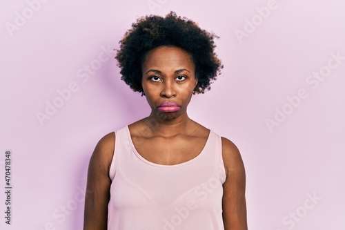 Young african american woman wearing casual sleeveless t shirt depressed and worry for distress, crying angry and afraid. sad expression.