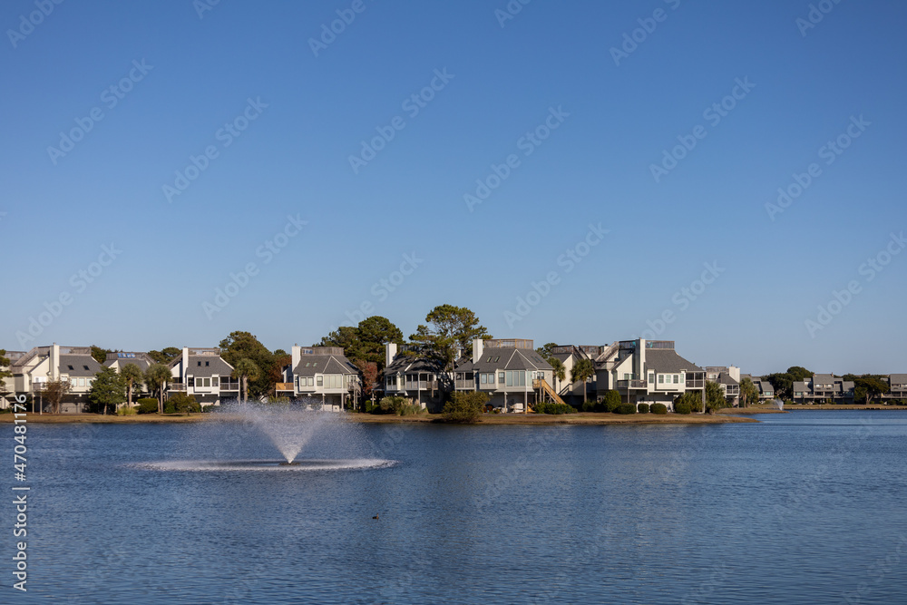 View of residential housing at Litchfield beach, South Carolina, USA. Lake and fountain visible