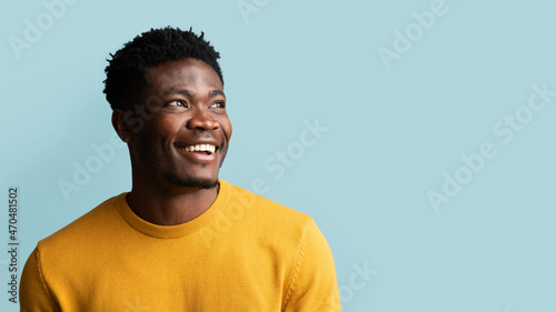 Closeup portrait of cheerful black guy looking at copy space