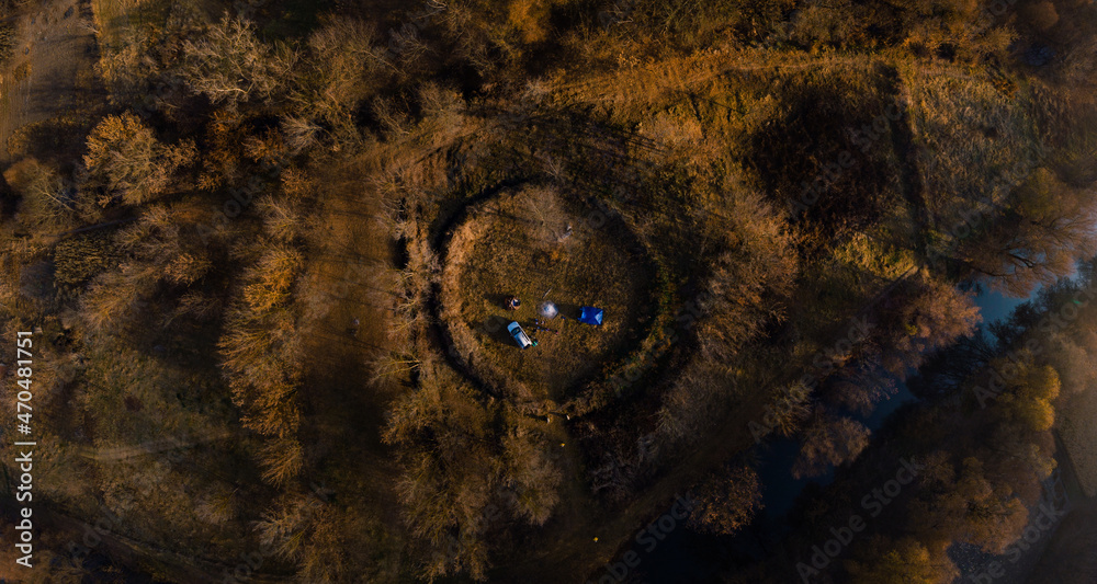 Aerial autumn sunrise view Temple of the Old Believers, a circle of earth. Overnight with a tent in the wild. Camping. SUV Vehicle with roof rack. Tourism and recreation. Busha Ukraine.