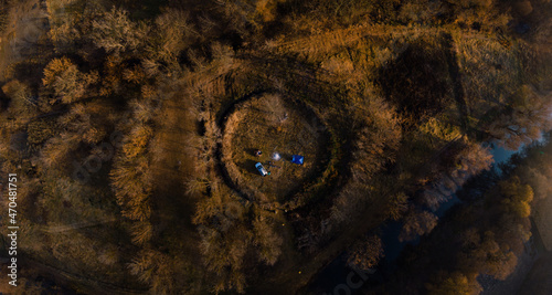 Aerial autumn sunrise view Temple of the Old Believers, a circle of earth. Overnight with a tent in the wild. Camping. SUV Vehicle with roof rack. Tourism and recreation. Busha Ukraine.